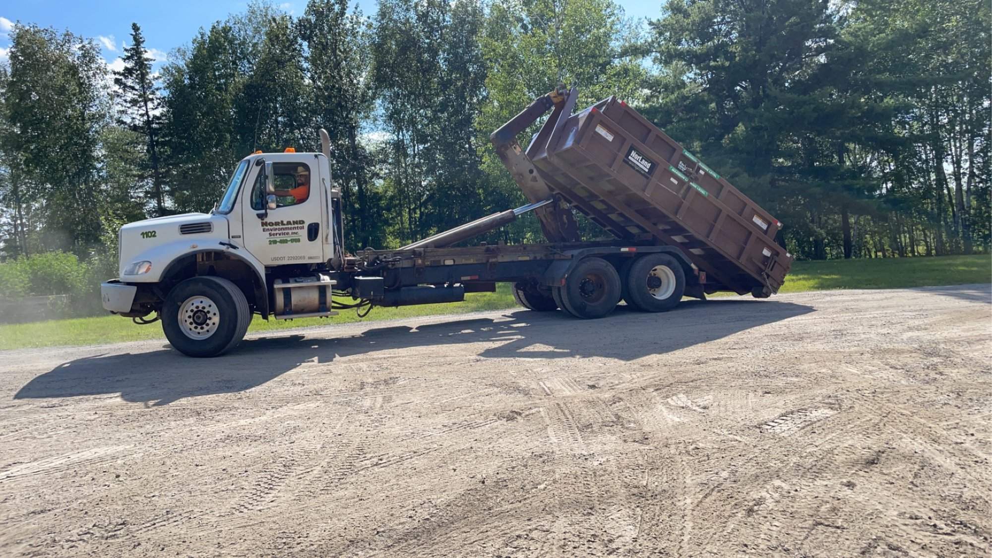 Walter's roll-off truck setting a container