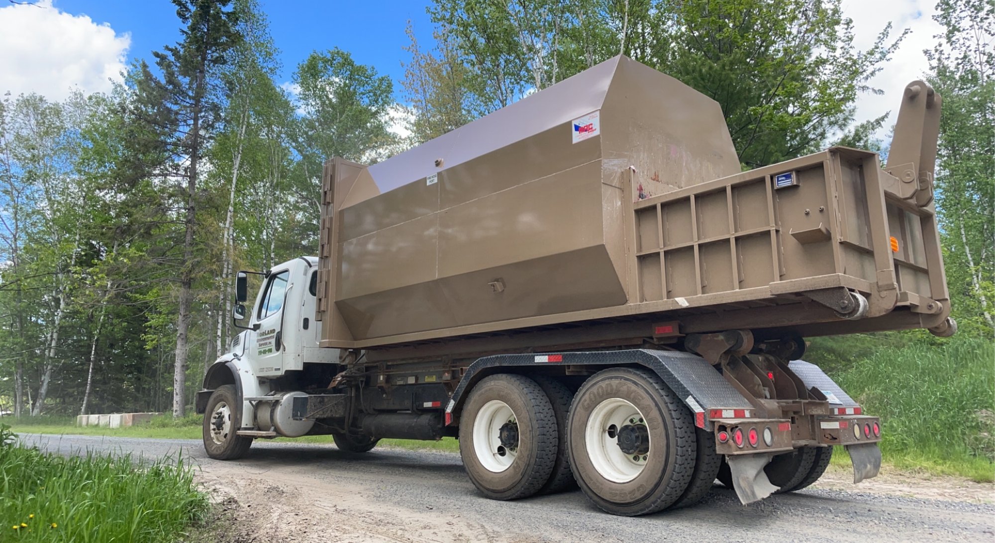 Roll-off container on the road